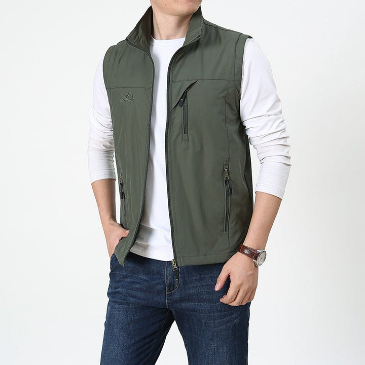 Man wearing an army green lightweight vest and jeans