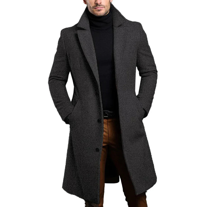 Man wearing a dark grey long overcoat with a sophisticated collar