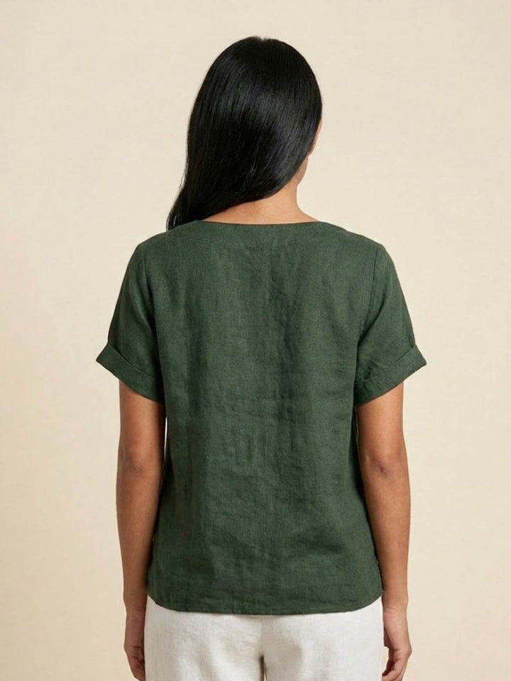 Flat lay of women's short sleeve scoop neck button tee