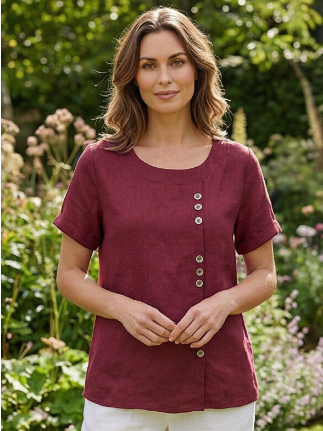 Close-up of buttons on women's short sleeve scoop neck top