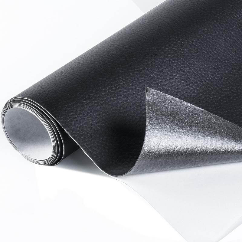 Leather repair patch seamlessly blending with a black couch cushion