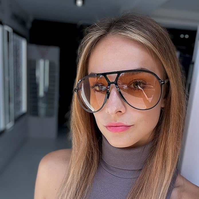 Woman wearing oversized square aviator sunglasses with orange gradient lenses