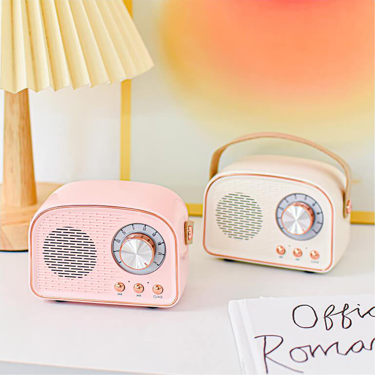 Pink and white retro Bluetooth speakers displayed together