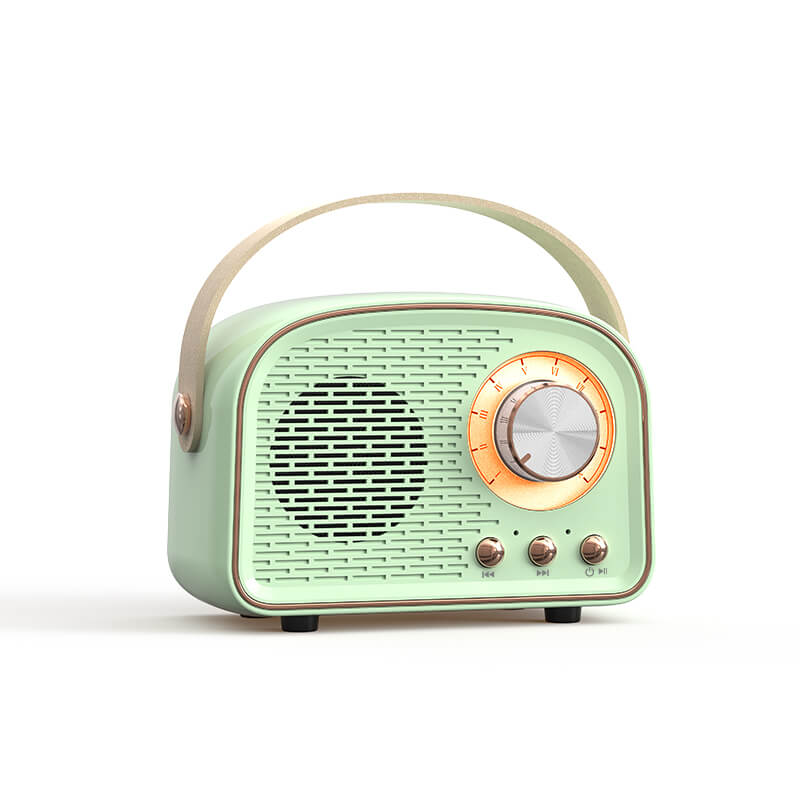 Hand holding the compact retro Bluetooth speaker for portable music listening