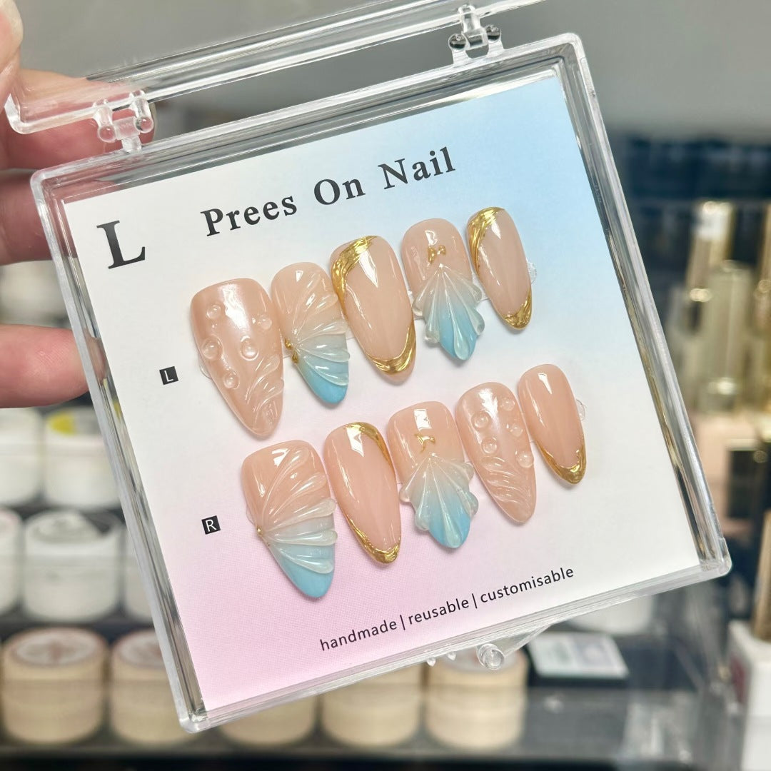 Handmade reusable press-on nail art set in light purple displayed in a clear box