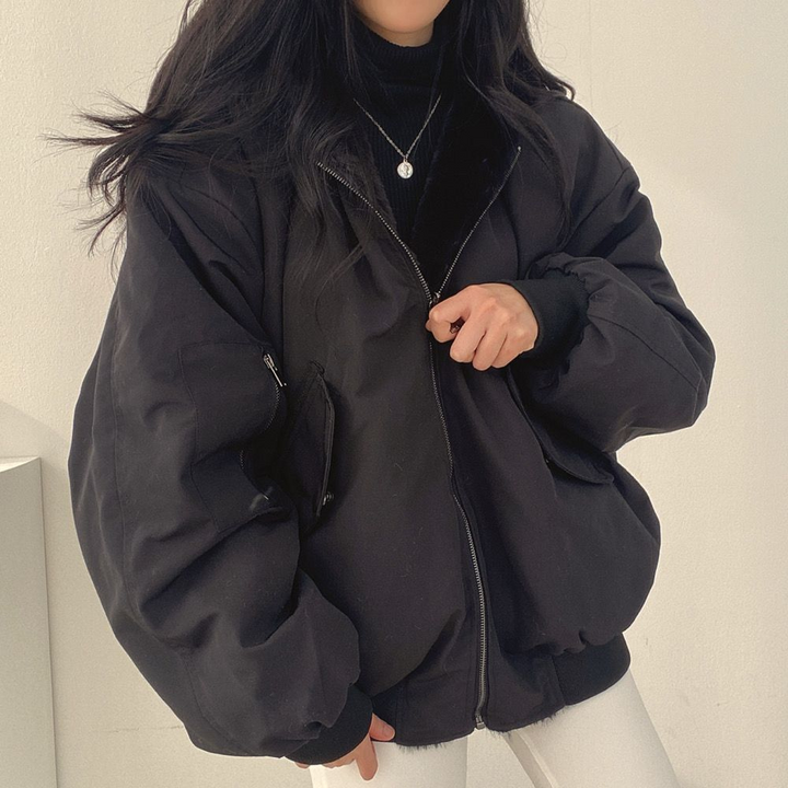 Lifestyle view of woman wearing blue winter coat outdoors