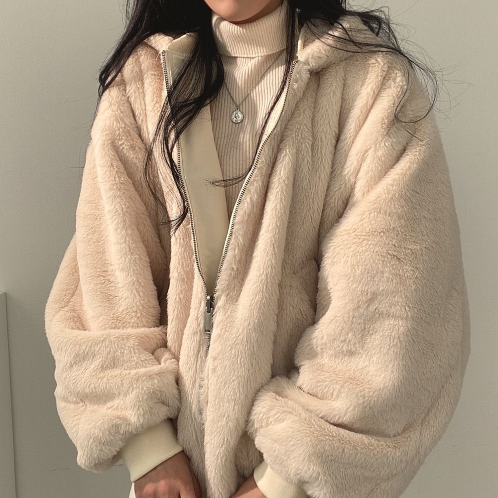 Close-up of front zipper and collar design on hooded jacket