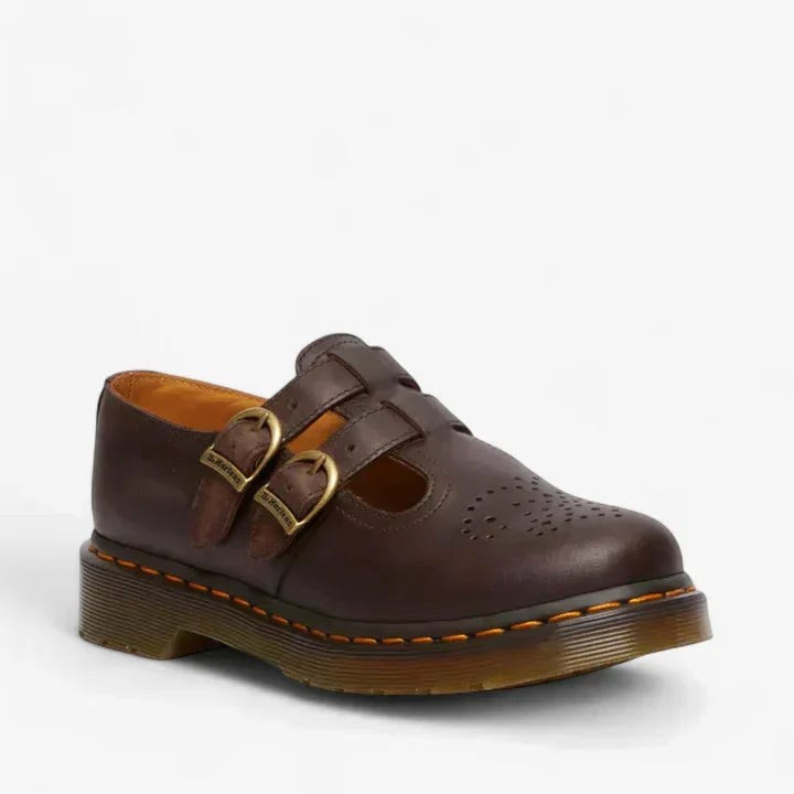 Women's brown double buckle Mary Jane flat shoe displayed on white background