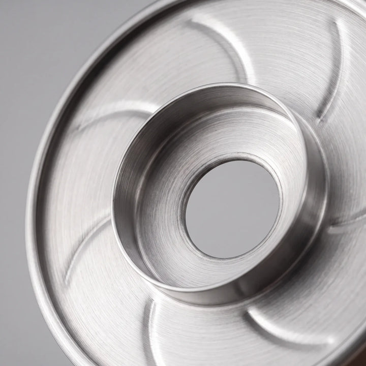 Stainless steel pour-over coffee dripper showing internal ribbed design for smooth flow