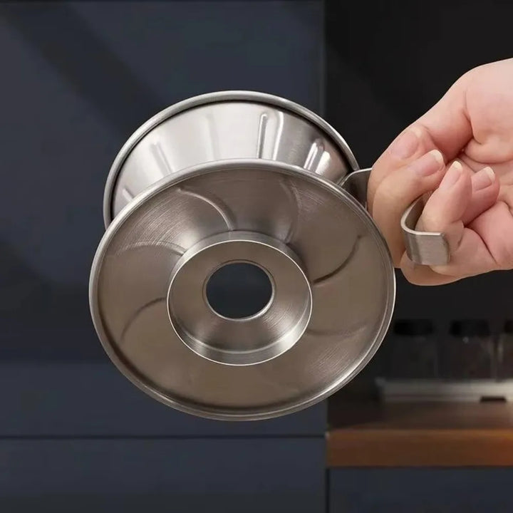 Close-up of metal coffee maker funnel showcasing durable stainless steel construction