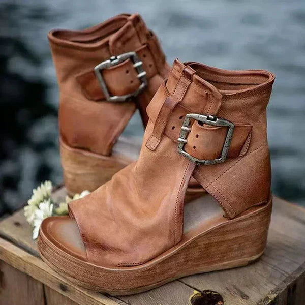 Women's ankle strap wedge sandals showing side profile and platform height