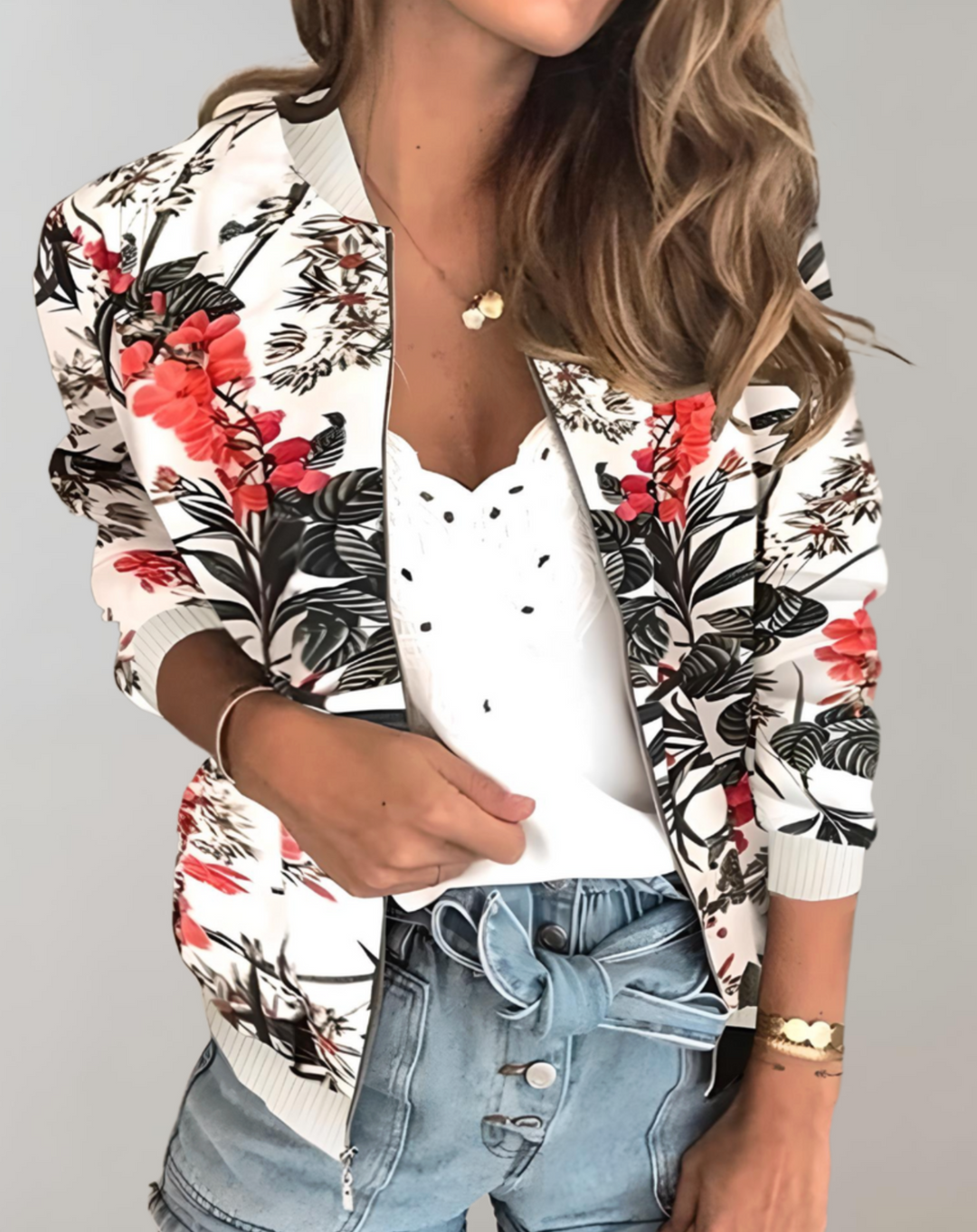 Back view of a casual floral bomber jacket for women featuring long sleeves and ribbed cuffs