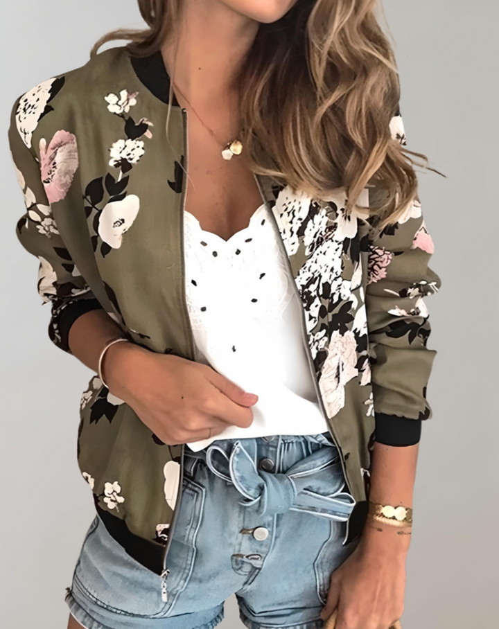 Woman wearing army green floral bomber jacket paired with denim shorts