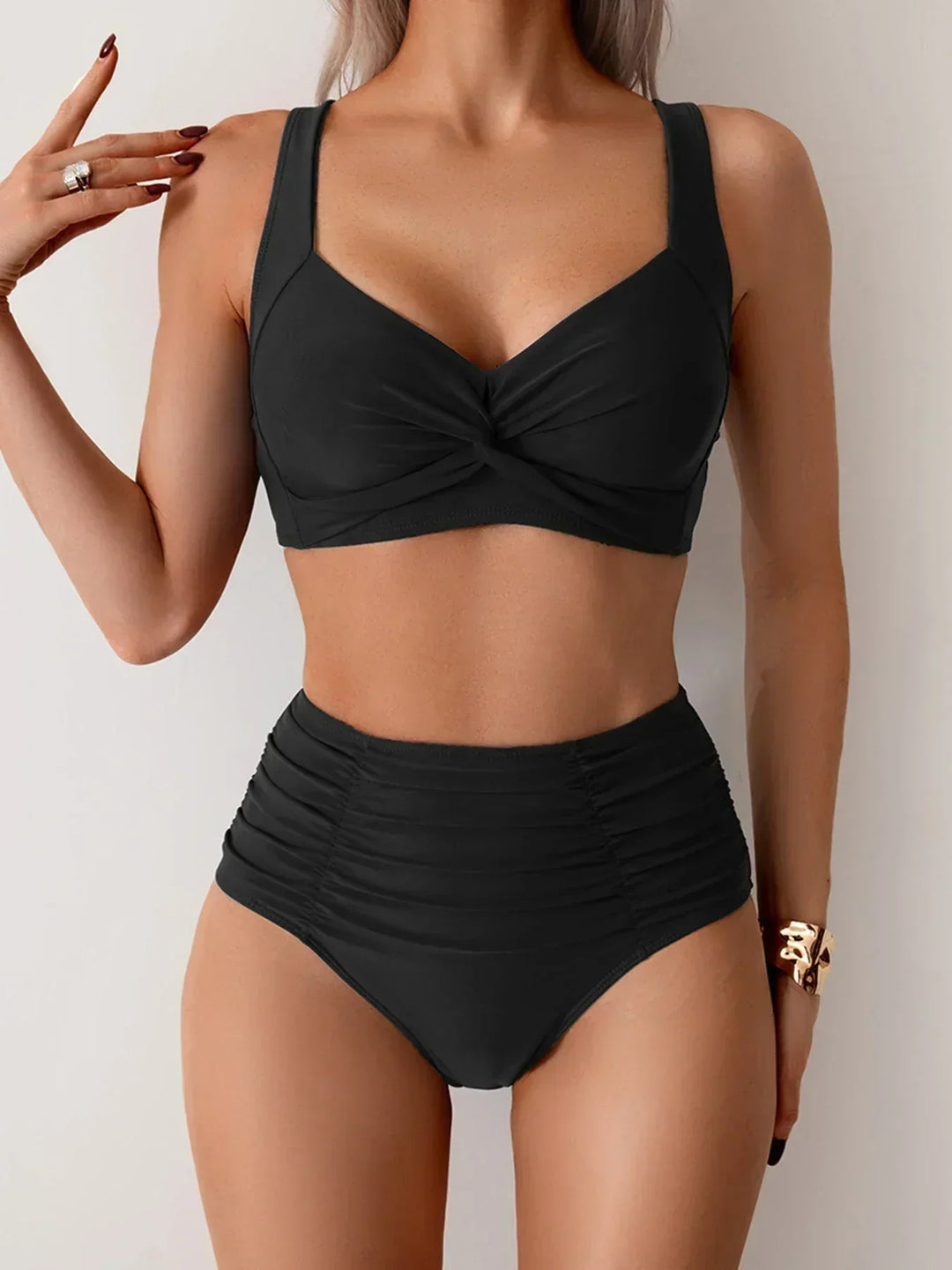 Woman wearing black high-waisted twisted bikini set
