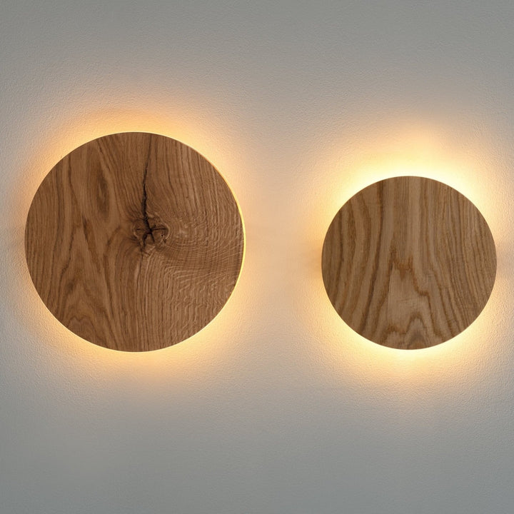 Minimalist round oak wood LED wall light showing warm scandinavian decor lighting