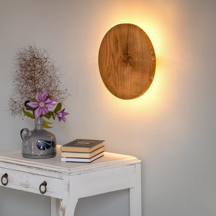 Close-up of wooden lamp fixture highlighting natural oak grain and LED glow