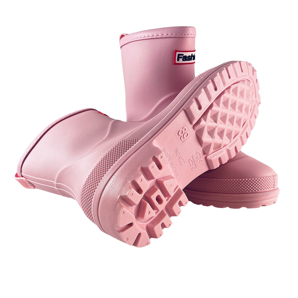 Pink women's waterproof rain boots showing treaded sole