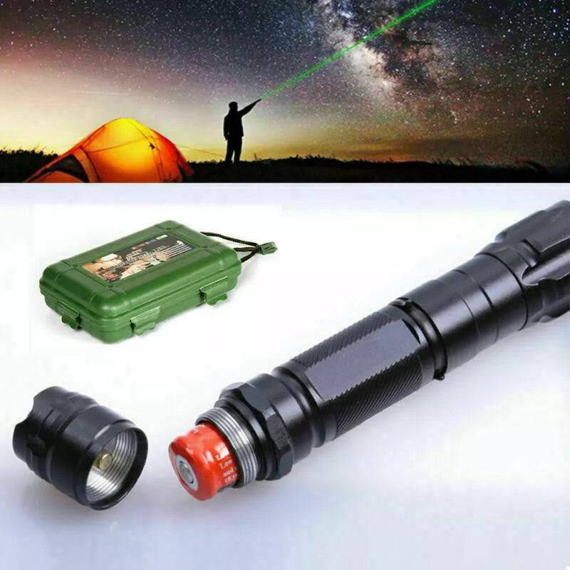 Green laser pointer used for stargazing outdoors next to storage case and battery