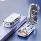 White adjustable pill cutter and storage box on display