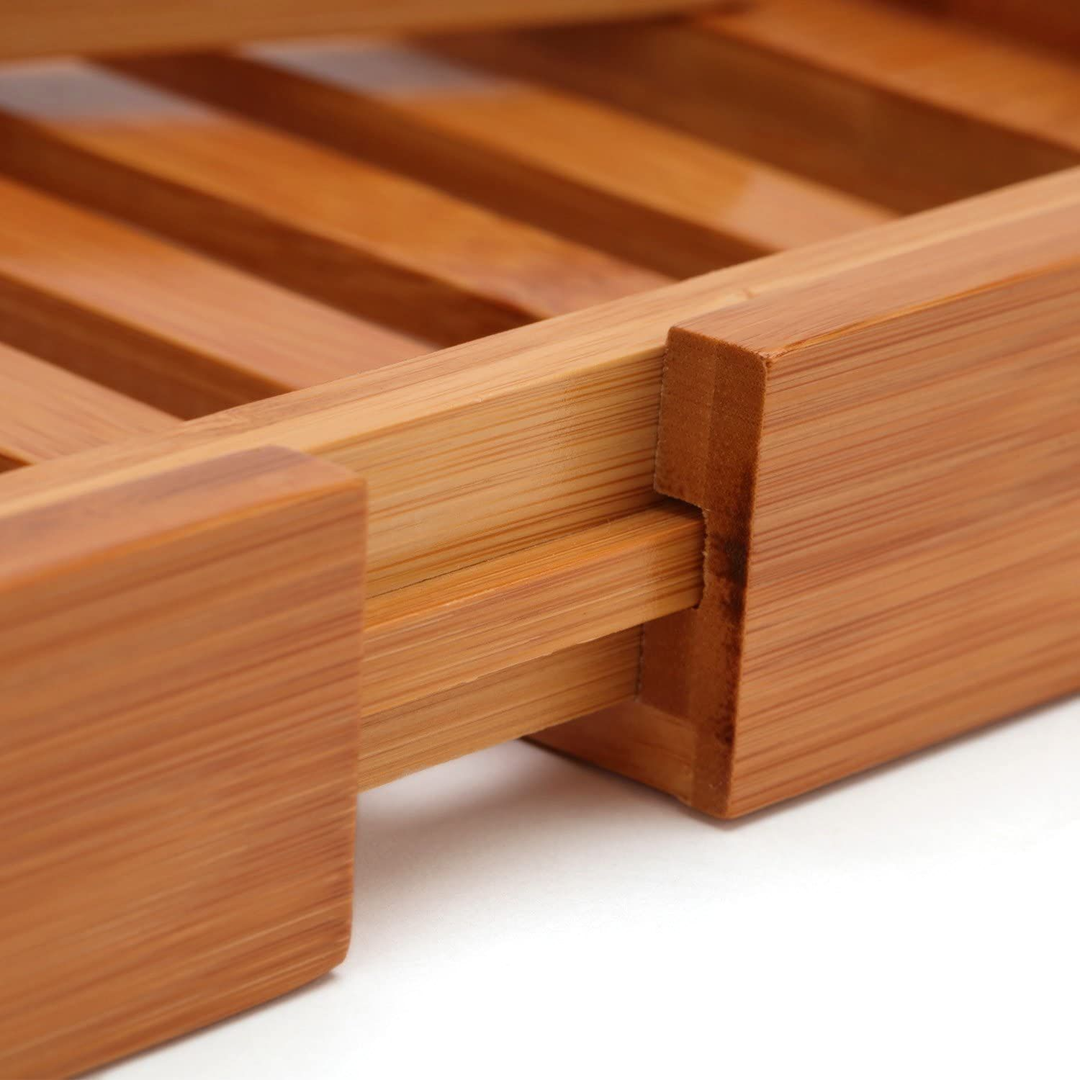 Side profile of adjustable bamboo bathtub shelf showing sturdy construction and depth