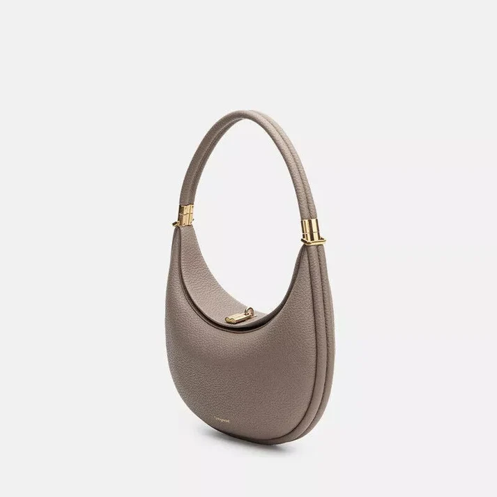 Convertible crossbody bag displayed with strap attached for casual wear