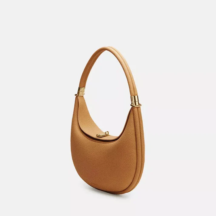 Detailed shot of metallic clasp closure on the elegant women's handbag