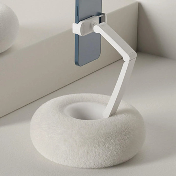 Close-up of white adjustable mobile phone holder pillow with mounted smartphone