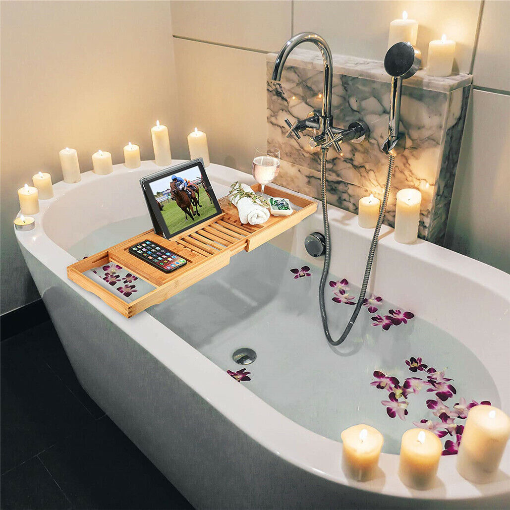 Close-up of bamboo bathtub tray showing built-in phone holder and accessory slots