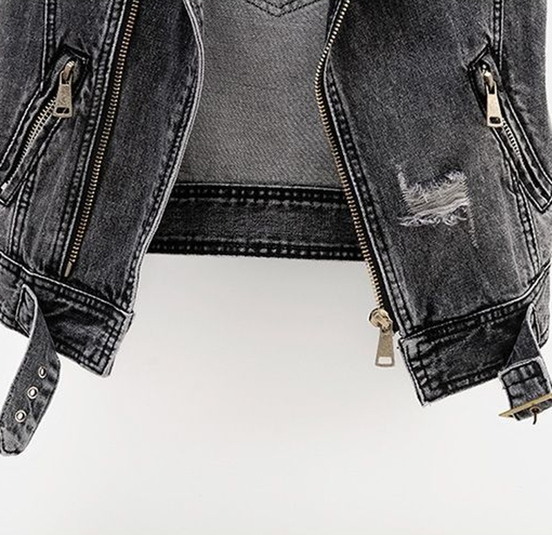 Close-up of zipper and distressed detailing on the dark grey denim waistcoat