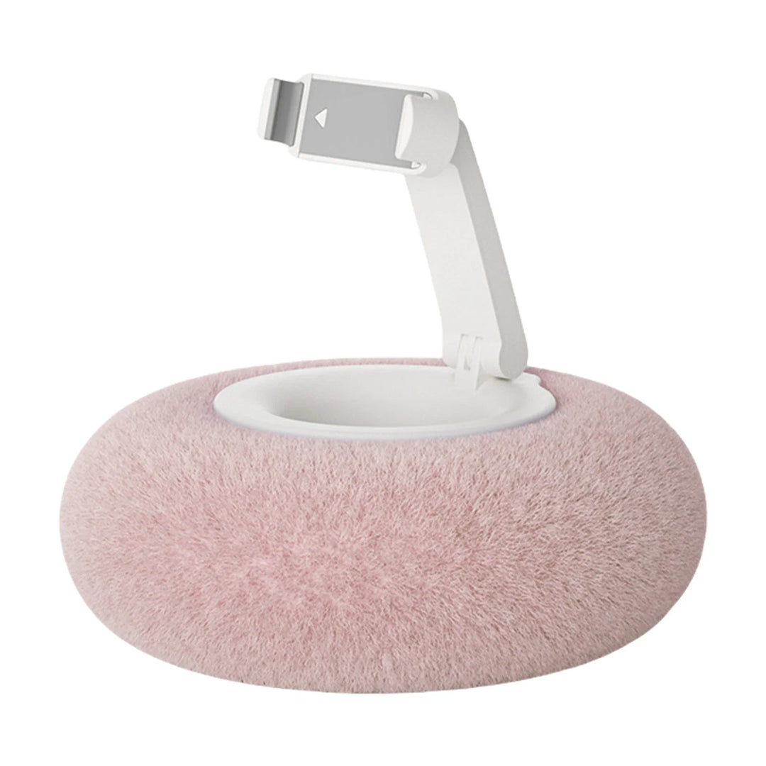 Pink mobile accessories pillow prop holding a smartphone vertically on a soft surface