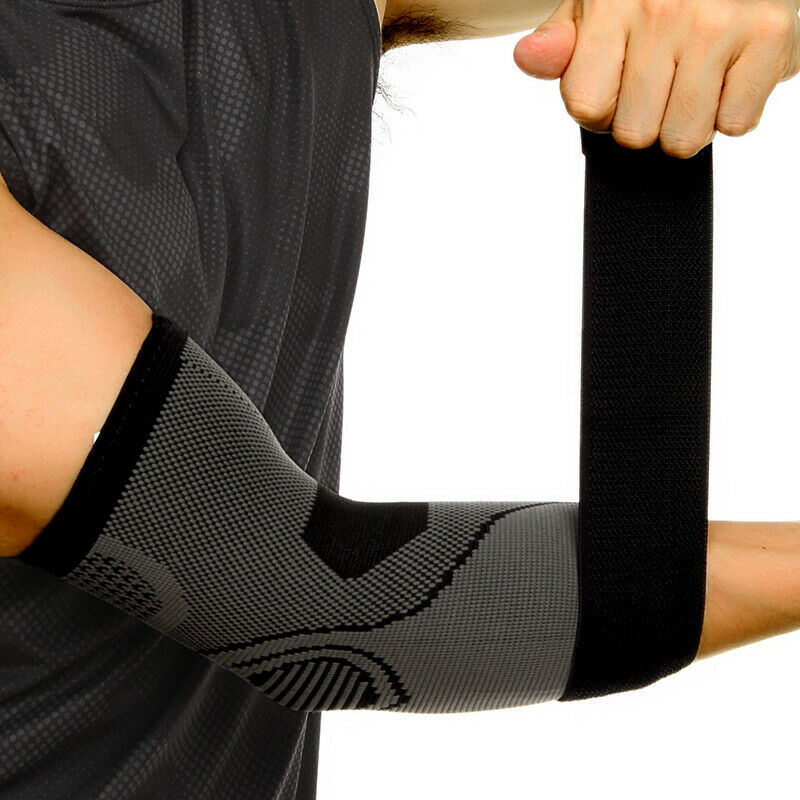 Person wearing a black compression elbow sleeve with an adjustable strap