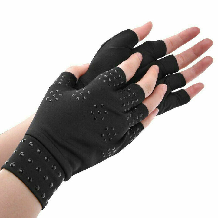 Person wearing black magnetic compression gloves with open fingers