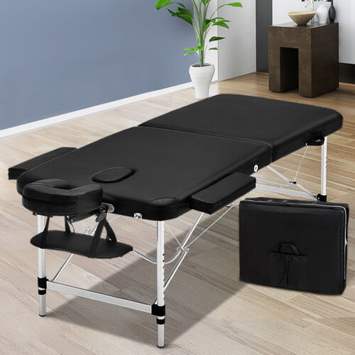 Black portable massage table shown alongside its convenient carrying bag