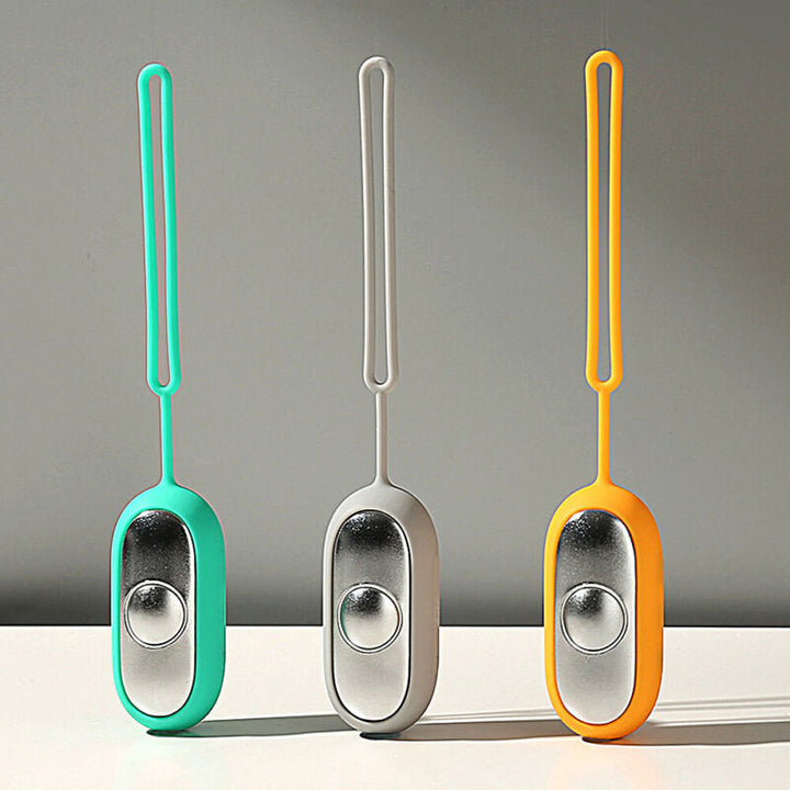 Handheld relaxation device held in palm demonstrating ergonomic fit.