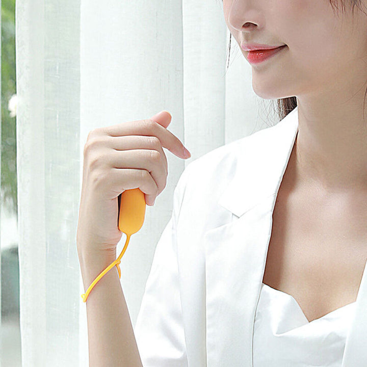 Handheld relaxation device showcasing control buttons and sleek finish.