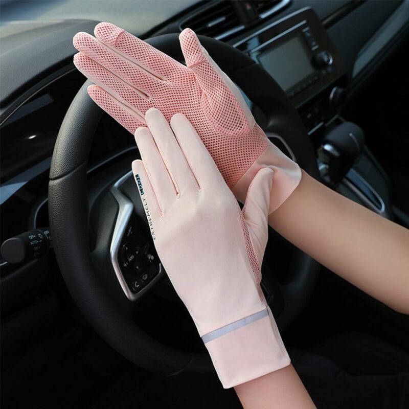 Woman wearing pink anti-uv mesh gloves while driving