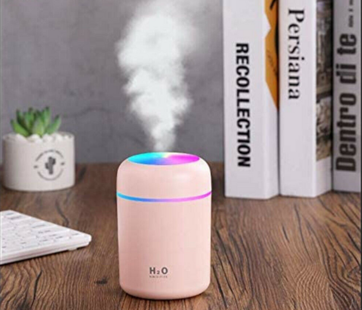 Mini USB air humidifier placed on a modern office desk setup