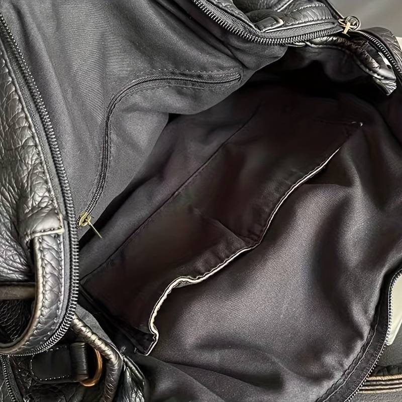 Interior view of women's black handbag showing lining and storage pockets