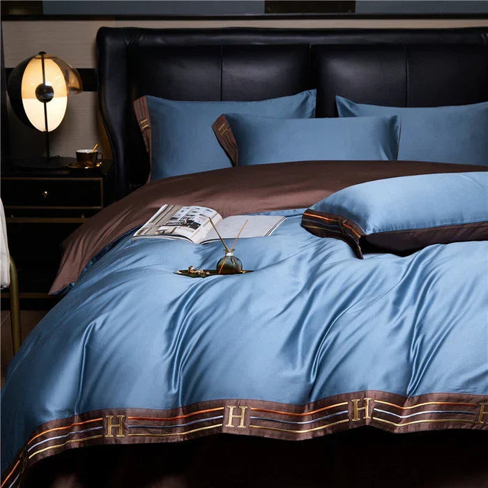 Set of matching satin pillowcases featuring intricate decorative stitching