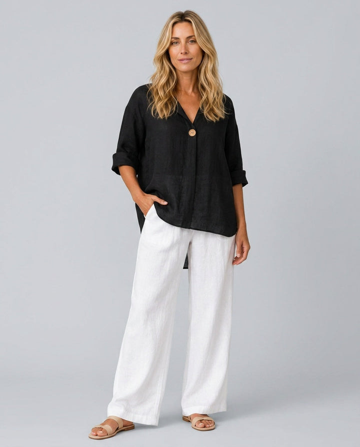 Full length front view of a woman wearing a black casual blouse