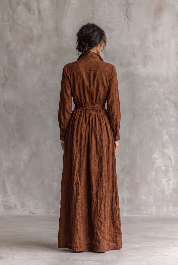 Woman wearing a dark brown relaxed zip front long sleeve maxi dress, back view