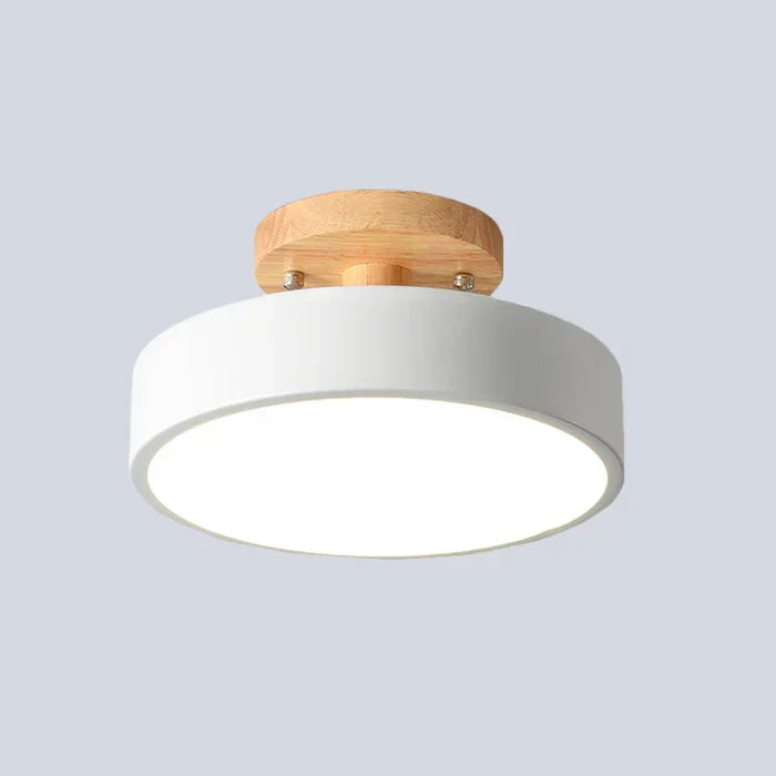 Scandinavian LED ceiling lamp in white mounted against a neutral background