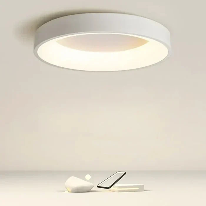 White Scandinavian round LED ceiling lamp mounted on a neutral ceiling