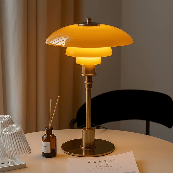 Amber and gold Scandinavian table lamp on a dining table with warm glowing LED light