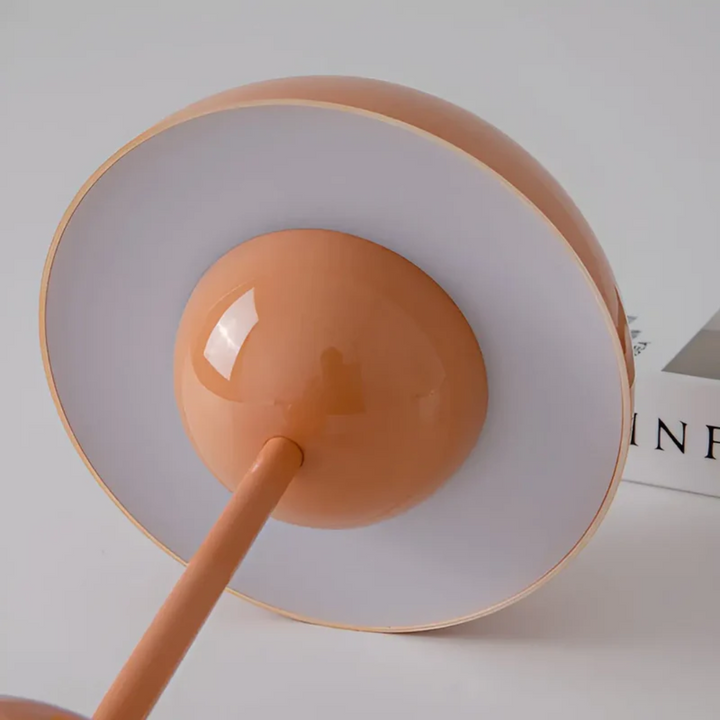 Ambient scandinavian lighting glowing softly on a nightstand at dusk