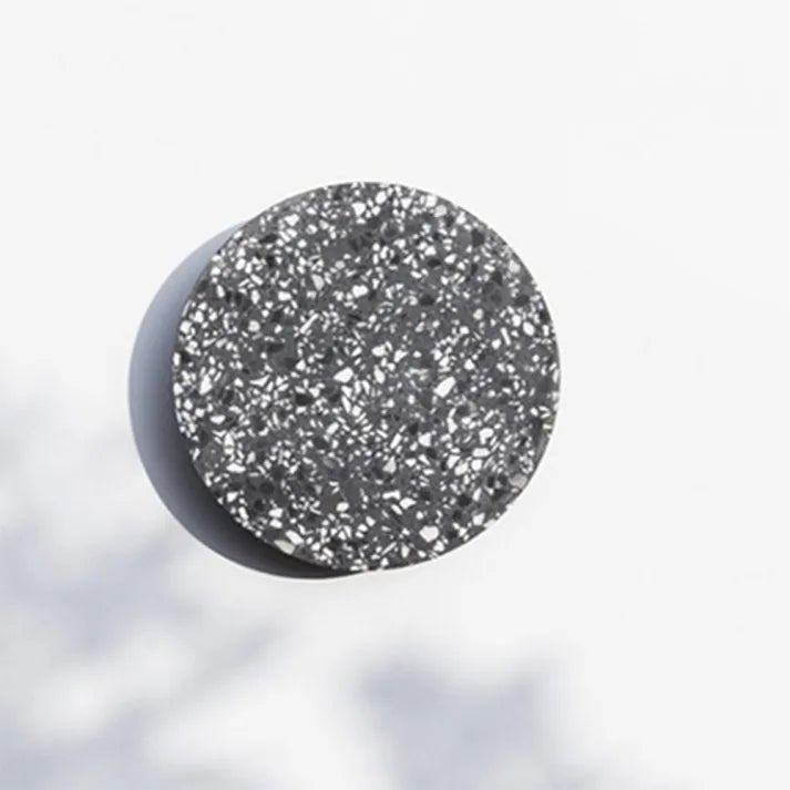 Close up of black terrazzo circular wall lamp surface