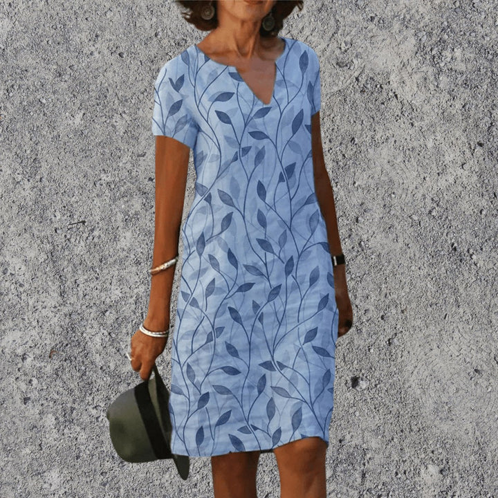 Woman wearing Light Blue V-Neck Midi Dress with leaf print