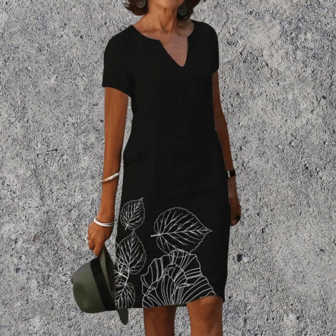 Women's V-neck botanical print midi dress showing short sleeves and floral pattern
