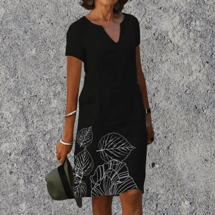 Women's V-neck botanical print midi dress showing short sleeves and floral pattern