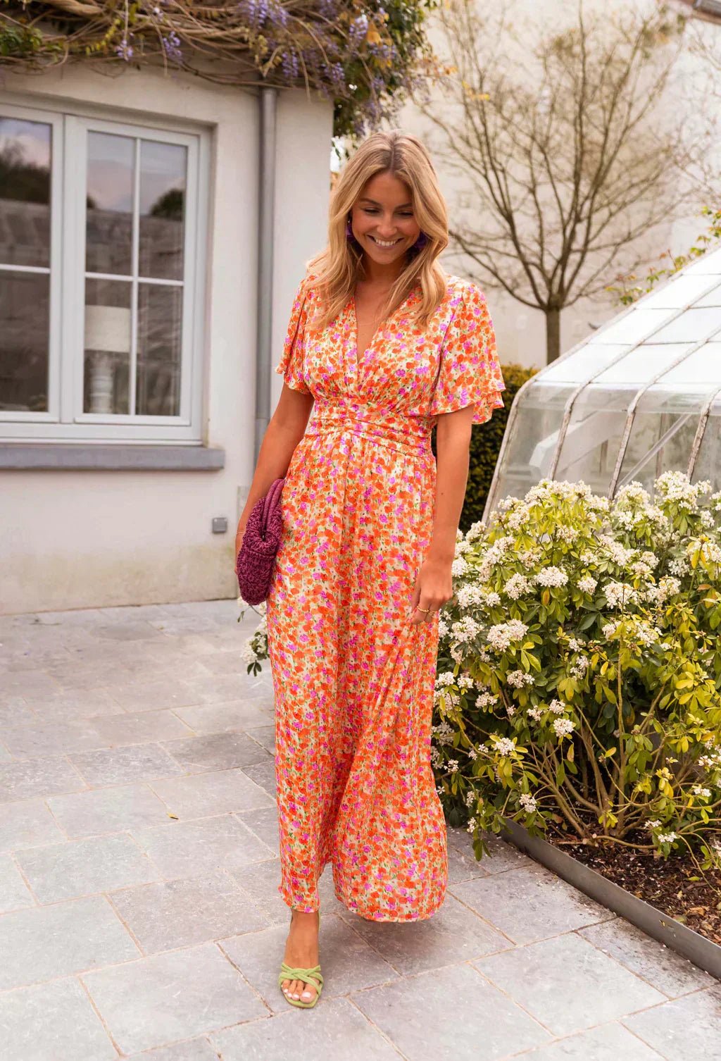 Side profile of elegant women's floral party maxi dress highlighting silhouette and movement
